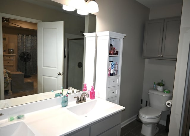 bathroom featuring vanity, tile patterned floors, toilet, and walk in shower