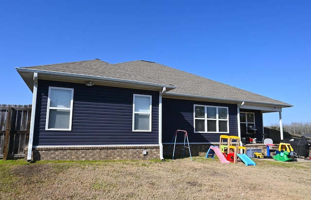 rear view of house featuring a yard