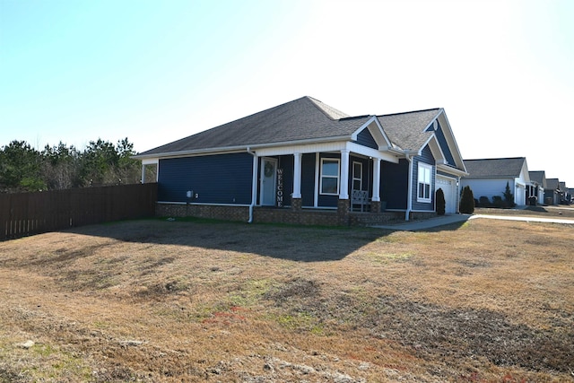 craftsman-style house with a garage, a porch, and a front lawn