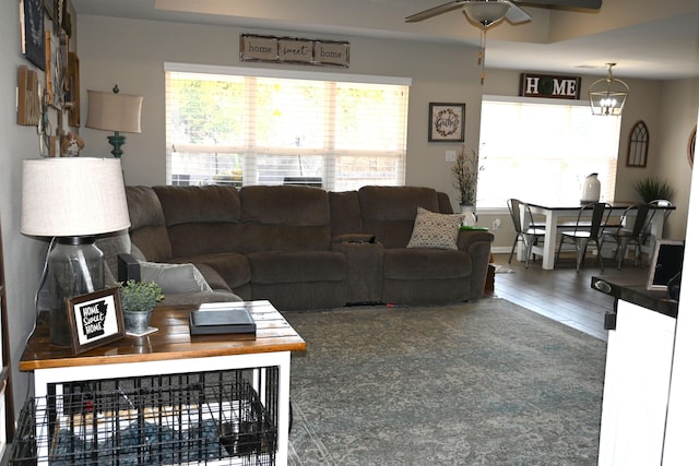 living room featuring wood-type flooring and ceiling fan