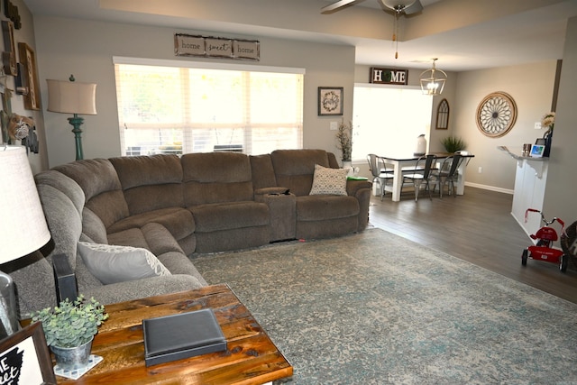 living room featuring a tray ceiling, dark hardwood / wood-style floors, and ceiling fan