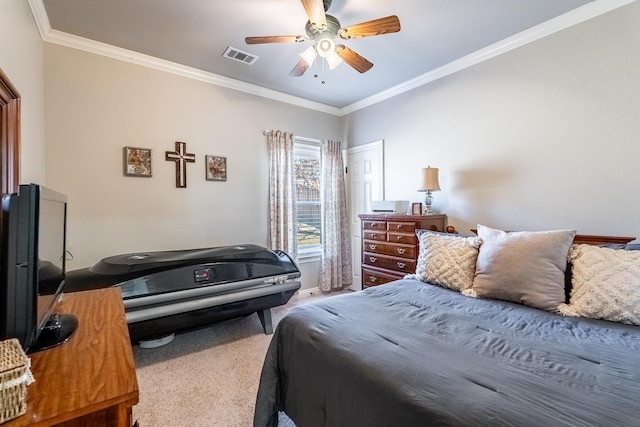 carpeted bedroom with ceiling fan and ornamental molding