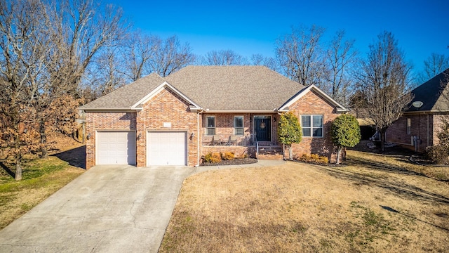 view of front of property with a garage and a front lawn