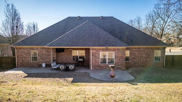 rear view of house with a patio area and a lawn