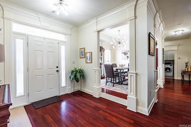 entryway with an inviting chandelier, ornamental molding, plenty of natural light, and washer / dryer