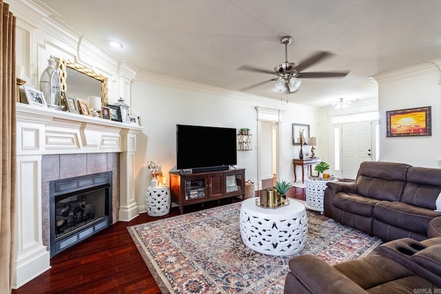 living room with ornamental molding, ceiling fan, a fireplace, and dark hardwood / wood-style flooring