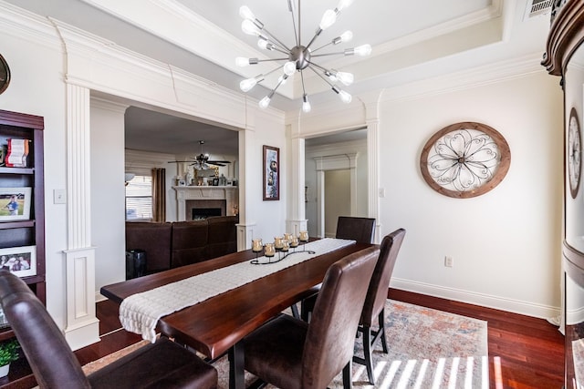 dining space with dark wood-type flooring, crown molding, and an inviting chandelier