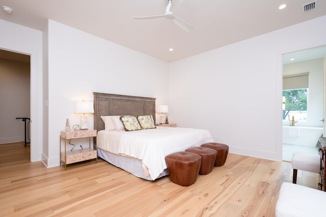 bedroom with ceiling fan, ensuite bath, and light hardwood / wood-style flooring