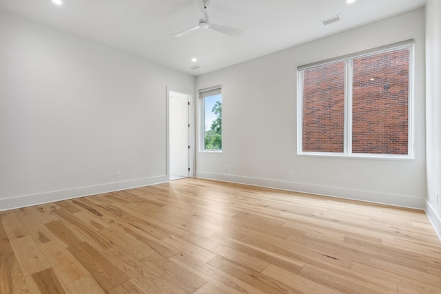 spare room featuring ceiling fan and light wood-type flooring