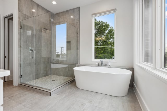 bathroom featuring independent shower and bath