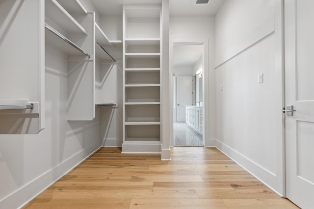 walk in closet featuring light hardwood / wood-style flooring