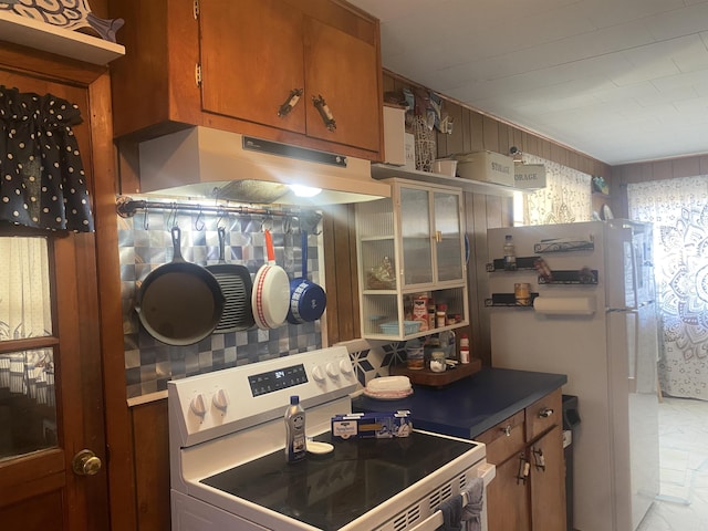 kitchen featuring white appliances and exhaust hood