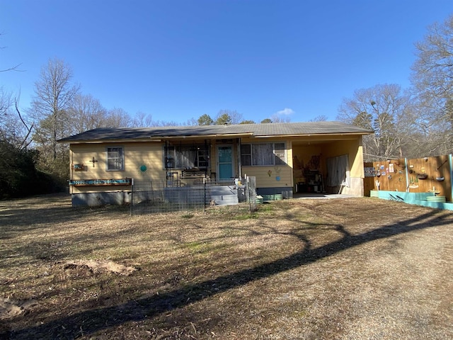 view of front facade with a front yard and a carport