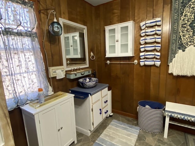 bathroom featuring wooden walls