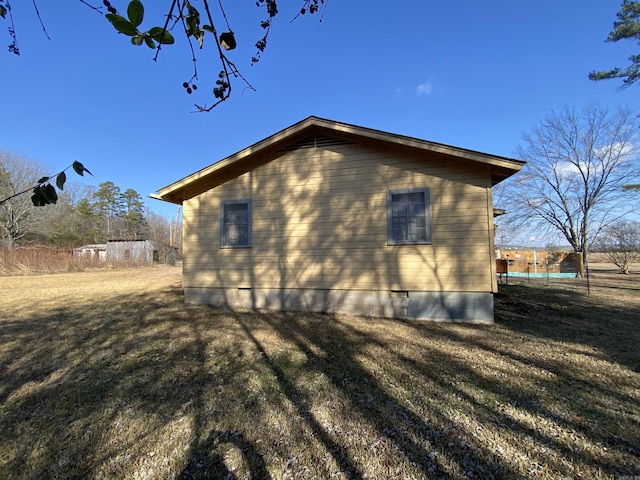 view of property exterior with a lawn