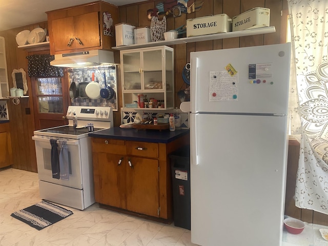 kitchen featuring white appliances and custom range hood