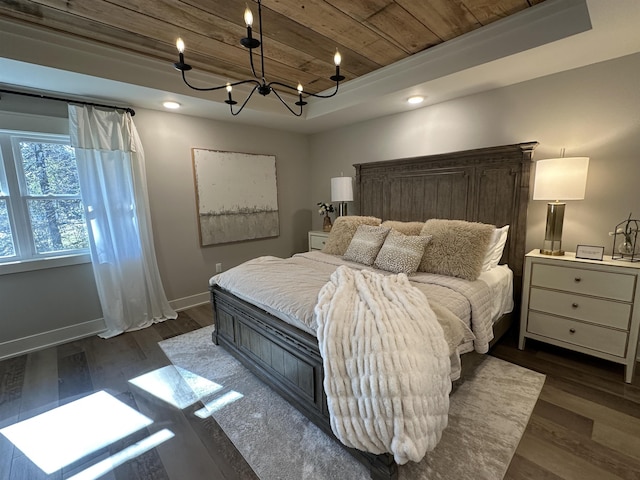 bedroom featuring wood ceiling, a tray ceiling, dark hardwood / wood-style flooring, and a chandelier