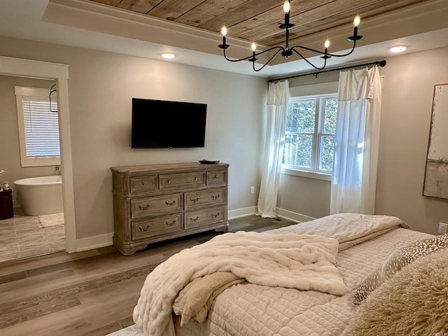 bedroom with hardwood / wood-style flooring, wooden ceiling, and ensuite bath