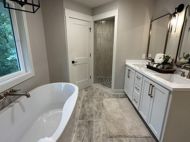 bathroom featuring vanity and shower with separate bathtub