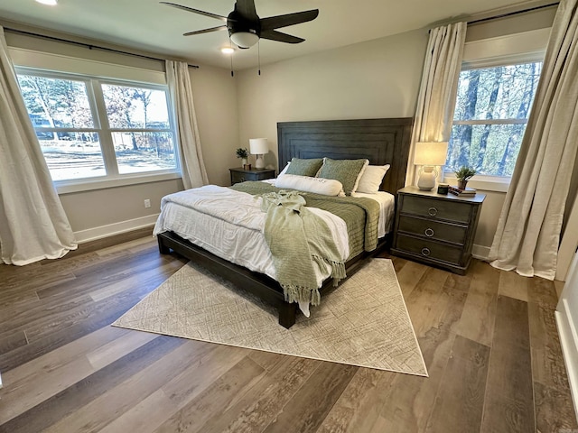 bedroom featuring multiple windows, ceiling fan, and light hardwood / wood-style flooring