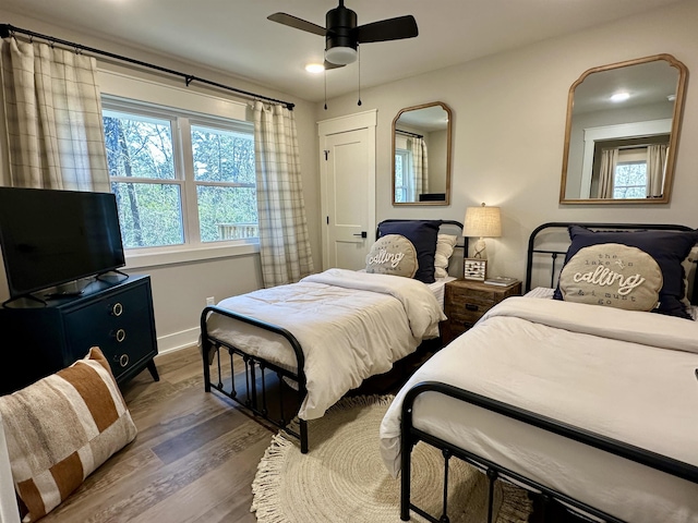 bedroom with hardwood / wood-style flooring and ceiling fan