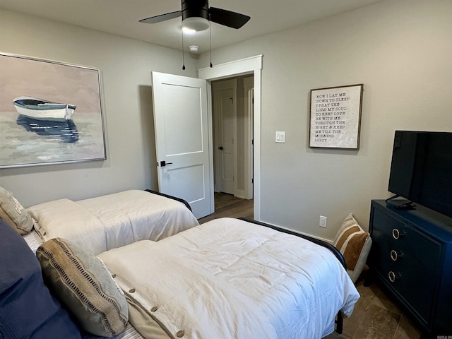 bedroom with ceiling fan and dark hardwood / wood-style floors