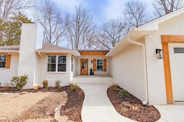 doorway to property with a garage