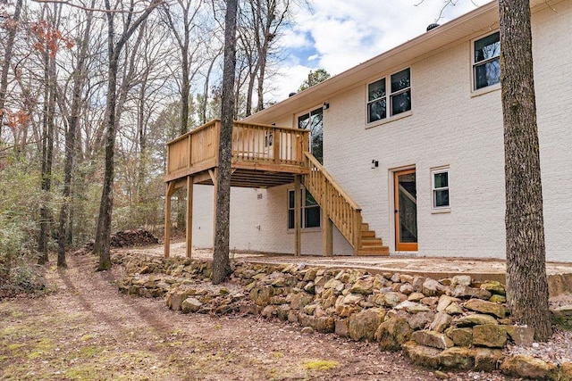 back of house with a wooden deck