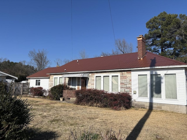 rear view of house with a lawn