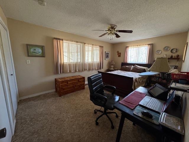 carpeted bedroom featuring a textured ceiling and ceiling fan