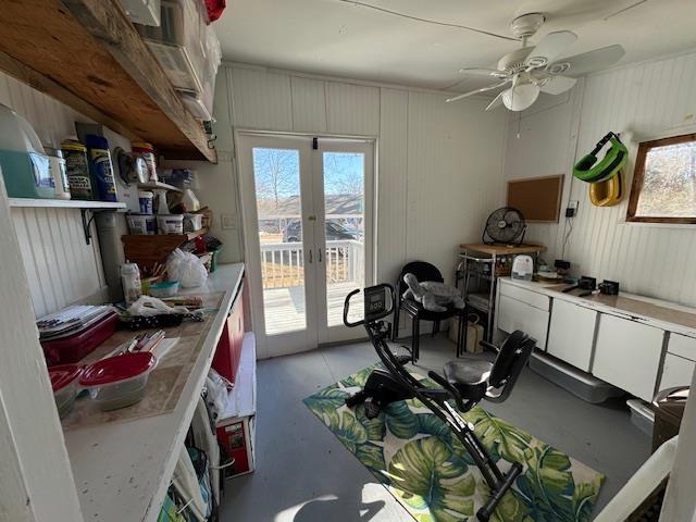 miscellaneous room with wood walls and french doors