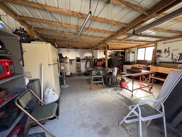 misc room with concrete flooring and a workshop area