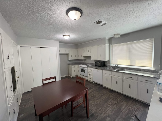 kitchen with sink, white appliances, dark wood-type flooring, white cabinetry, and a textured ceiling