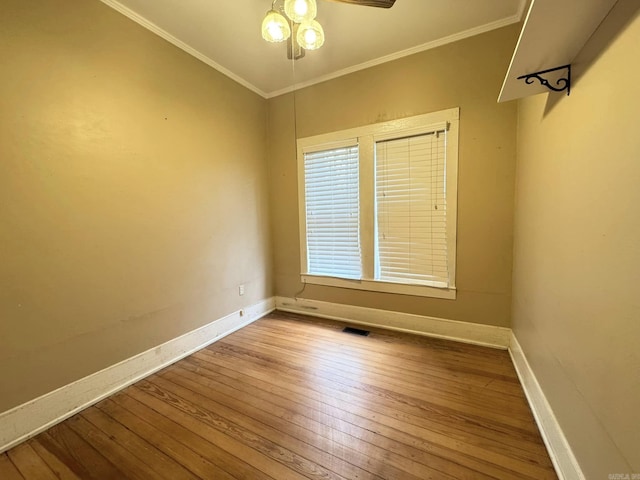 empty room featuring hardwood / wood-style flooring, ceiling fan, and crown molding