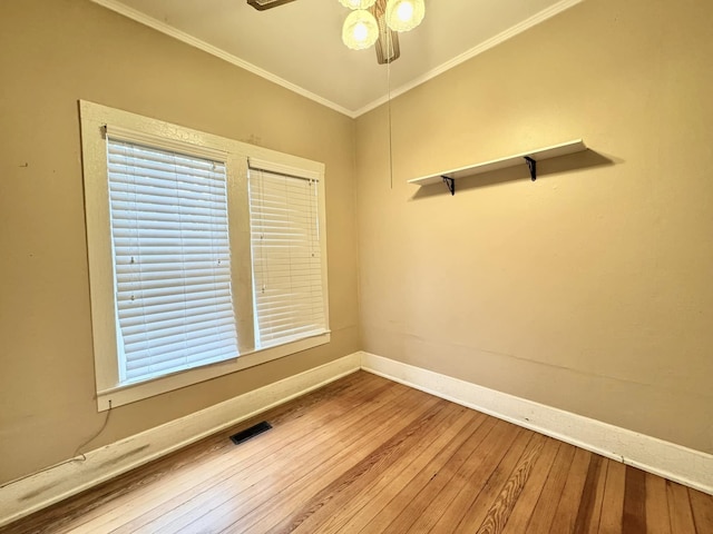 empty room with ceiling fan, ornamental molding, and hardwood / wood-style floors