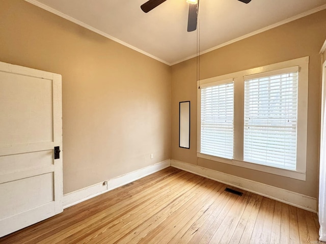 unfurnished room with ornamental molding, ceiling fan, and light wood-type flooring