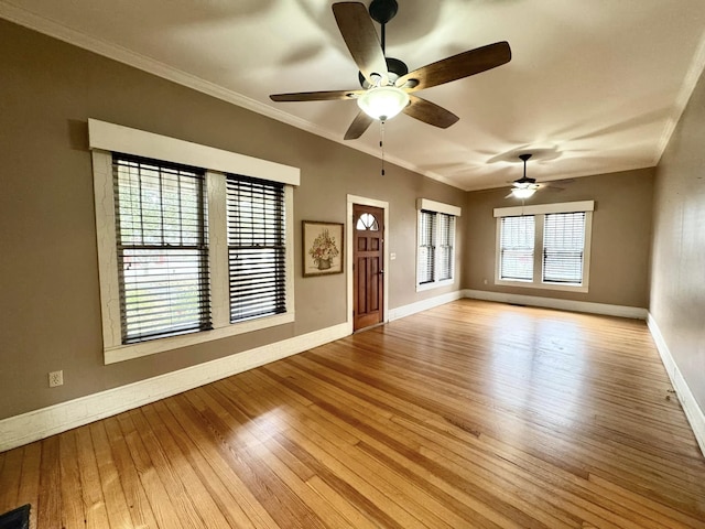 empty room featuring crown molding and light hardwood / wood-style flooring