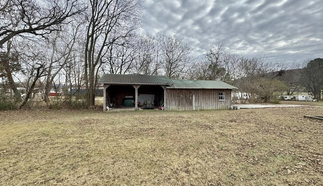 view of outbuilding featuring a yard