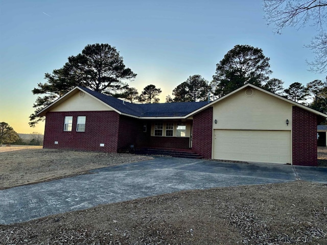 ranch-style home featuring a garage