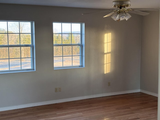 spare room with ceiling fan and wood-type flooring