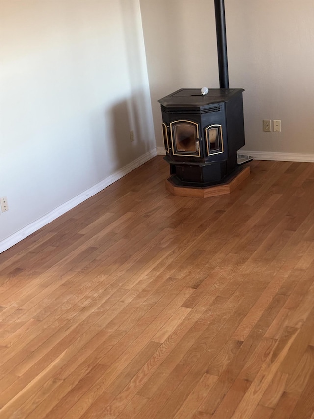 room details with wood-type flooring and a wood stove