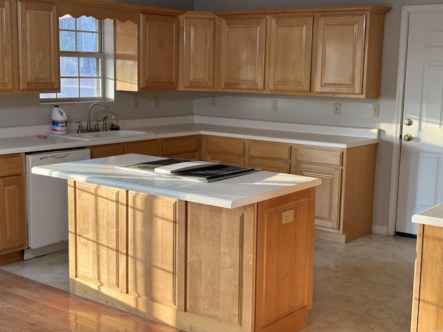 kitchen featuring sink, stainless steel dishwasher, and a center island