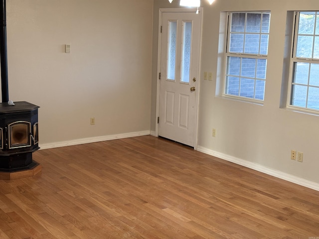 interior space featuring light hardwood / wood-style flooring and a wood stove