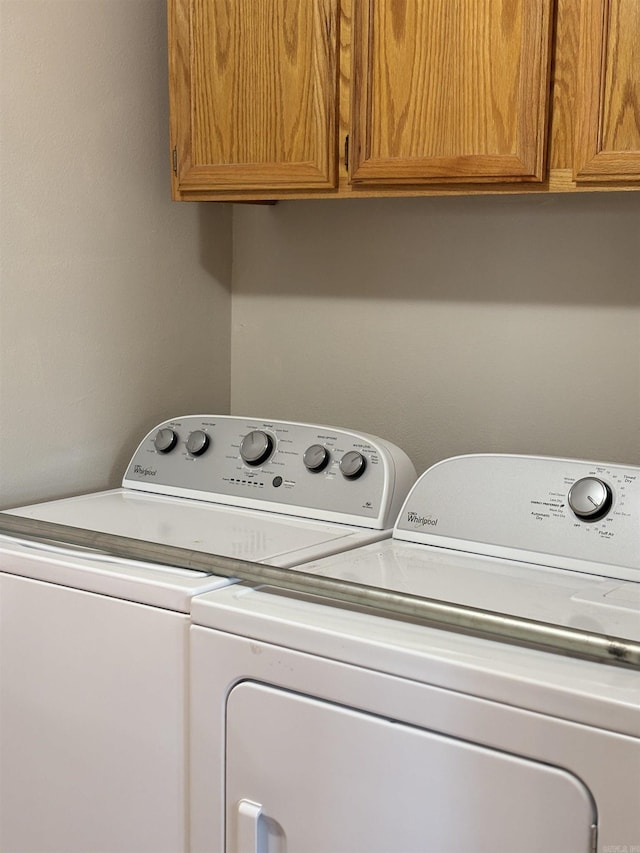 laundry room featuring cabinets and separate washer and dryer