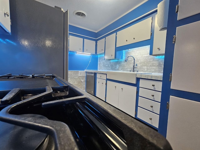 kitchen featuring white cabinetry, sink, and dishwasher