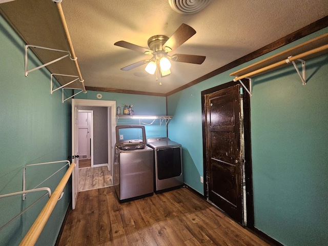 clothes washing area with crown molding, ceiling fan, dark hardwood / wood-style floors, a textured ceiling, and separate washer and dryer