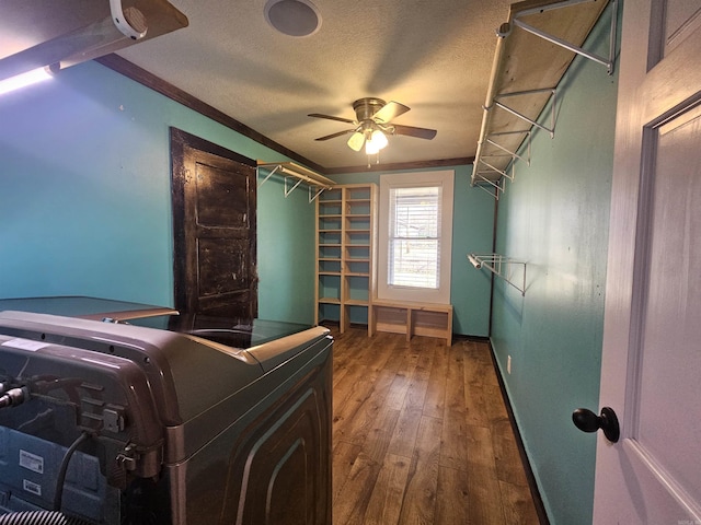 interior space with washer and dryer, dark hardwood / wood-style flooring, ceiling fan, crown molding, and a textured ceiling