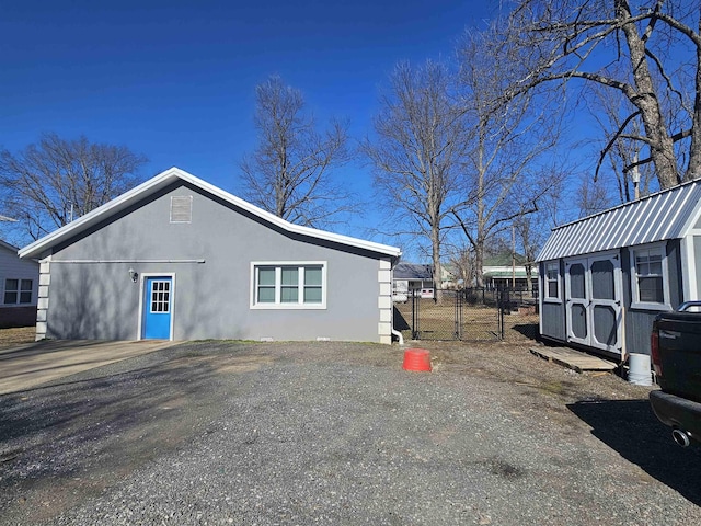 view of home's exterior with a storage shed