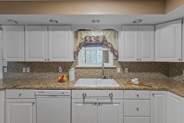 kitchen with white cabinets, backsplash, sink, and dishwasher