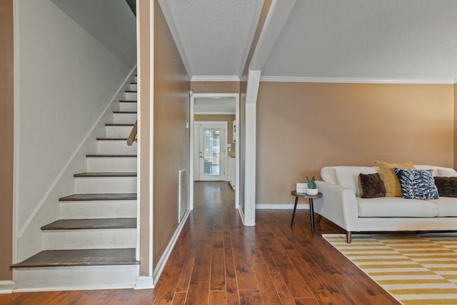 stairs featuring crown molding and wood-type flooring